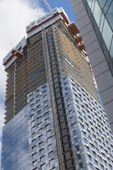 Obraz premium Forma East Tower, a residential and retail/commercial structure, designed by Frank Gehry, featuring rippling stainless-steel panel facade, located at 266 King St W, Toronto