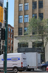 Obraz premium view of a Penske Truck Leasing vehicle stopped at the intersection of Spadina Av and Adelaide St W (with view of 101 Spadina, a condominium complex), Toronto