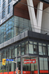 Obraz premium exterior building facade and sign of Wendy's, a fast food restaurant, located at 110 Blue Jays Way / 357 King West Condos, Toronto