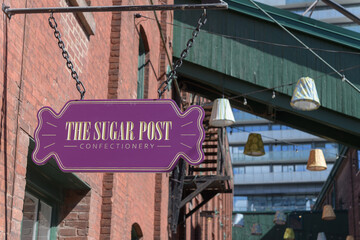 Obraz premium projecting novelty shaped signage outside The Sugar Post, a new candy store at the Distillery District, Toronto