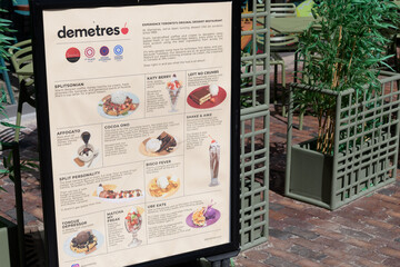 Obraz premium explanatory menu poster outside Demetres Desserts Distillery District, a dessert restaurant, located at 28 Gristmill Lane, Toronto