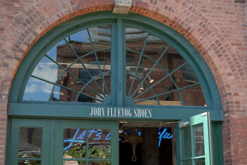Obraz premium historic building exterior and arched windowed portal of John Fluevog shoes shop sign at Distillery District at 4 Trinity Street, Toronto