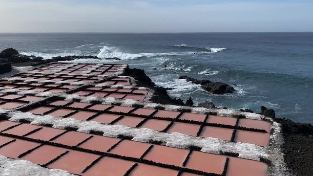 Salt pans on the seashore with gentle waves and clear sky, Salt pans, Fuencialente, La Palma, Canary Islands, Spain