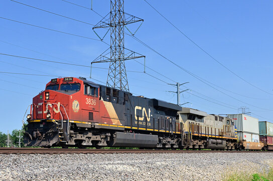 A Canadian National Railway intermodal freight train rolls southbound while passing through the southwestern suburbs of Chicago.