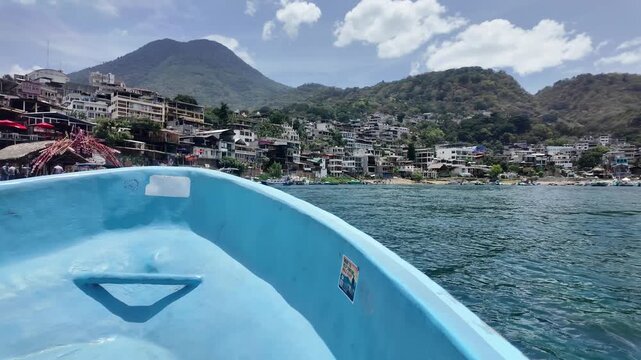 Boat bow on Lake Atitlan with a hillside town in the distance