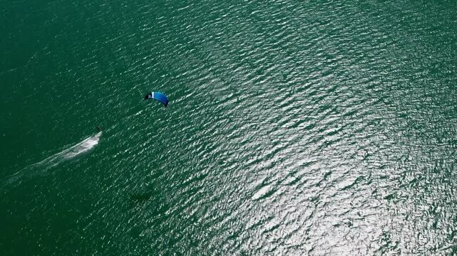 Drone view of a kitesurfer from above at Lake Mondsee, sun reflection in the water, Mondseeland, Salzkammergut, Upper Austria, Austria
