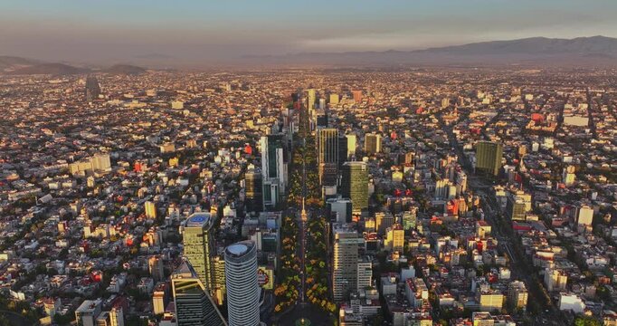 Mexico City Aerial v27 drone flyover and above avenue paseo de la reforma with skyscrapers on the sideline, capturing downtown cityscape at sunset golden hours - Shot with Mavic 3 Cine - December 2021