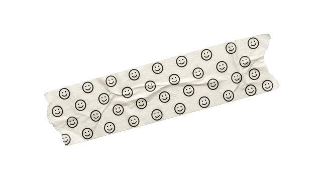 Wrinkled washi tape scrap with black smiley face pattern on cream paper