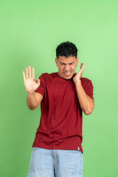 Young man showing repulsion and refusal gesture