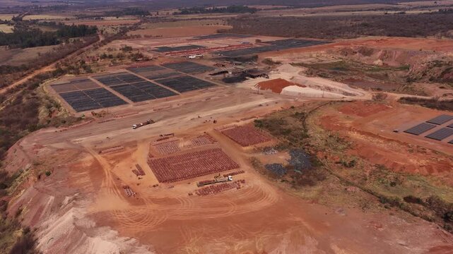 Brick manufacturing at brickyard in brown dusty countryside, aerial view
