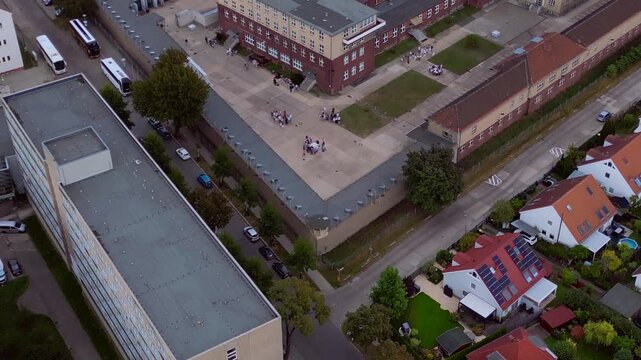 Berlin Hohenschoenhausen Memorial, a former Stasi prison, representing political persecution and communist dictatorship. Lovely aerial view drone panorama tilt up