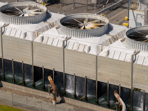 Aerial close up of cooling tower fan stacks at an industrial plant