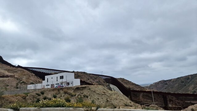 Border Barrier Across Hillside Landscape in Tijuana Mexico