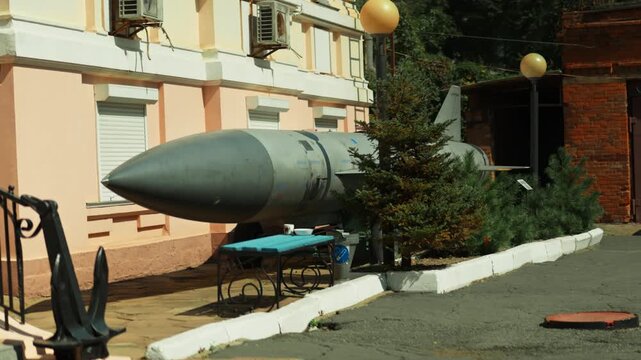 Obsolete, abandoned, and rusty combat missiles and shells stand amidst the natural landscape. A weapons graveyard. An echo of war. The aftermath of war.