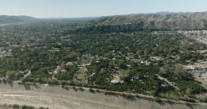 aerial view of suburban valley with town and houses