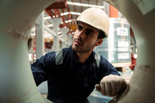 Engineers and staff are inspecting the assembly line system in a metal sheet and metal roofing manufacturing plant.
