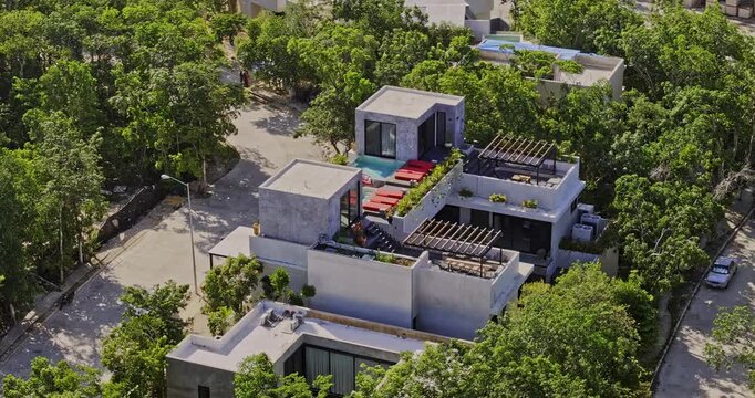 Tulum Mexico Aerial v11 zoomed birds eye view flyover capturing the building exterior and rooftop pool surrounded by lush greenery - Shot with Mavic 3 Pro Cine - July 2023