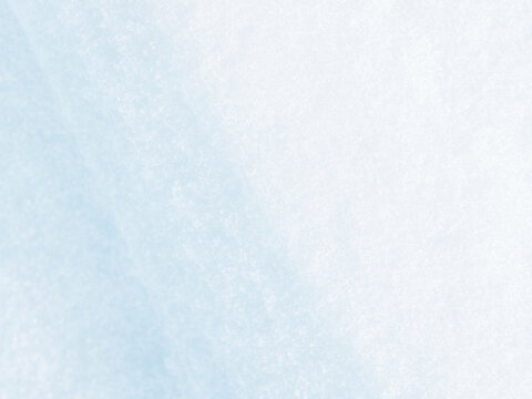 Beautiful winter background with snowy ground. Natural snow texture. Wind sculpted patterns on snow surface.