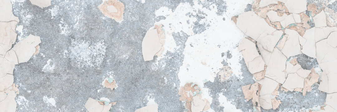 Peeling paint on the wall. Old concrete wall with cracked flaking paint. Weathered rough painted surface with patterns of cracks and peeling. Grunge texture for background and design. High resolution.