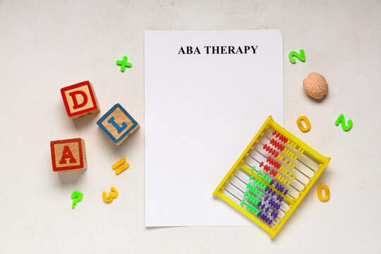 Aba therapy and autism support, paper with educational toys and abacus for child development and behavioral intervention on a textured background