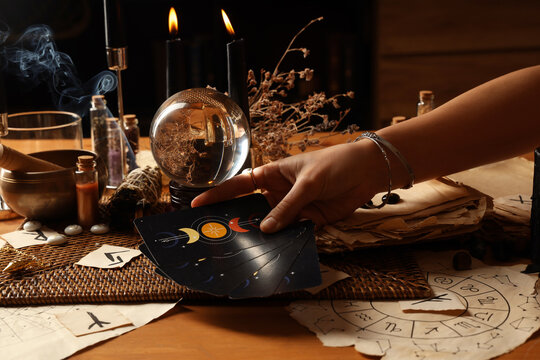 Fortune teller with tarot cards reading future  at table