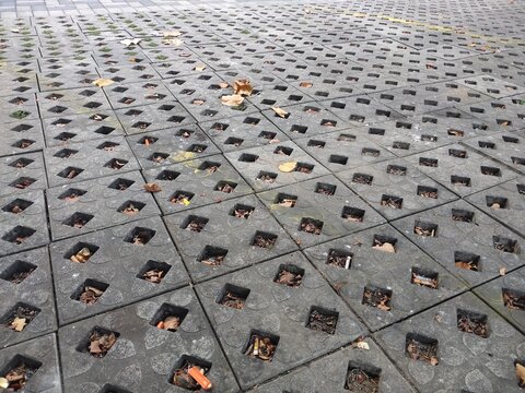 Unique interlocking concrete block pattern with a central opening for rainwater infiltration