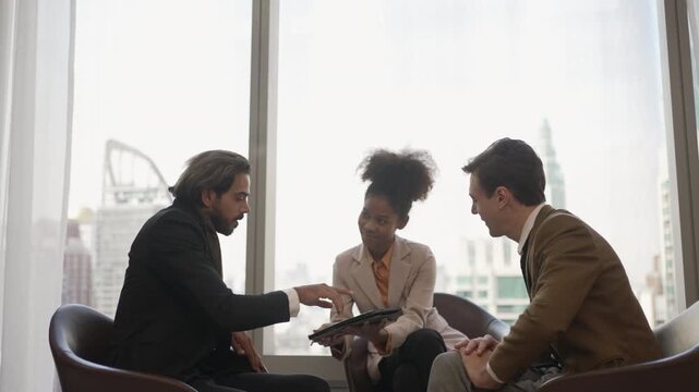 Businessman signs document with digitized pen in office lounge