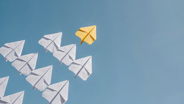 One yellow paper plane leading a formation of white paper planes on blue background with leadership innovation business strategy different teamwork creative motivation direction competition