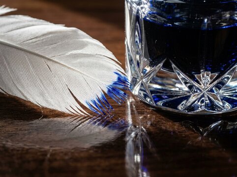 Feather Quill and Ornate Inkwell Filled with Blue Ink for Writing