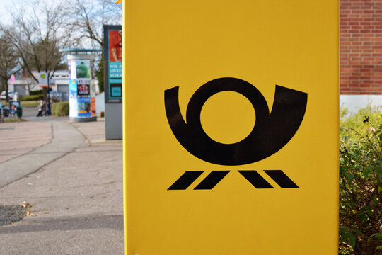 Heidelberg, Germany - February 22th 2025: Close up of yellow official German public mail box in city street