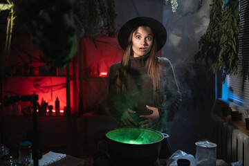 Shocked Amazed witch brewing a potion in cauldron looking at camera expression omg emotion. Blend of everyday life with traditional witchcraft, magic and mystical atmosphere © Andrii Lysenko