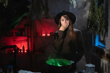 Shocked Realistic witch brewing a potion in cauldron looking horror movie online. Blend of everyday life with traditional witchcraft, magic and mystical atmosphere © Andrii Lysenko