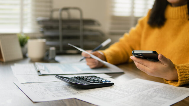 The concept of tax return preparation and financial management. Businessman calculates taxes. finance, Income tax, tax documents, and savings.