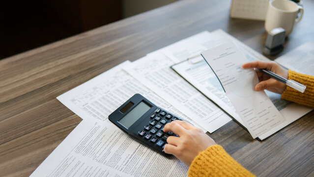 The concept of tax return preparation and financial management. Businessman calculates taxes. finance, Income tax, tax documents, and savings.