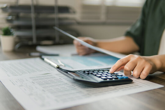 The concept of tax return preparation and financial management. Businessman calculates taxes. finance, Income tax, tax documents, and savings.