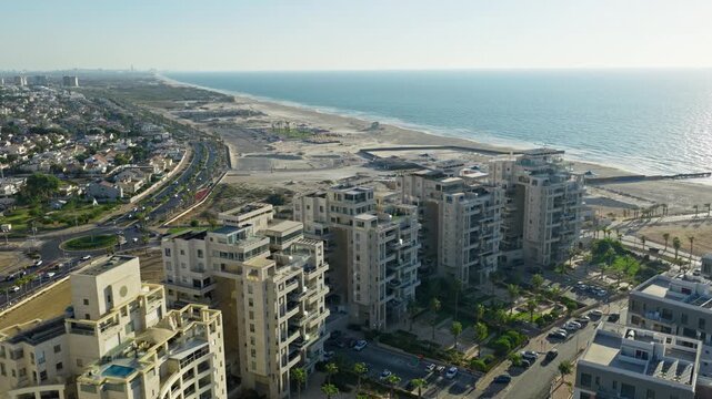 Aerial drone shot of luxury residential buildings and penthouses located in Ashdod Israel with the Mediterranean Sea and coastline in the background.