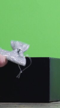How to remove gift wrapping ribbons from a box on a green screen