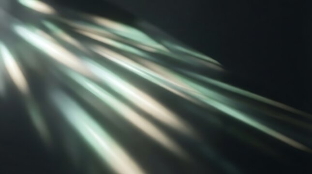 Soft diffused white and teal light rays reflecting on a dark surface with abstract background