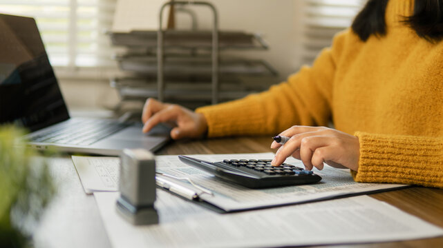 The concept of tax return preparation and financial management. Businessman calculates taxes. finance, Income tax, tax documents, and savings.