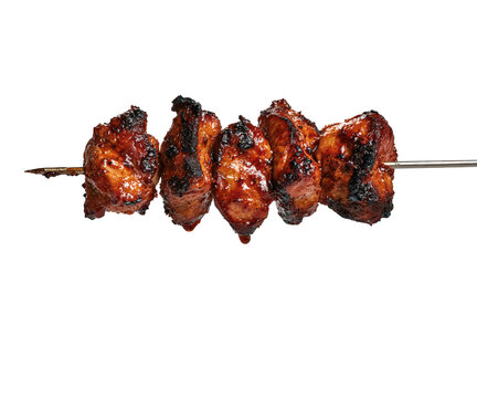 Grilled pork meat skewer with charred pieces isolated on transparent background