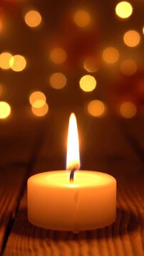 Close Up Candle Flame Flickering Gently with Warm Bokeh Lights Background