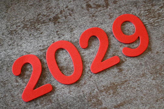 Red numerals 2029 on a textured gray surface