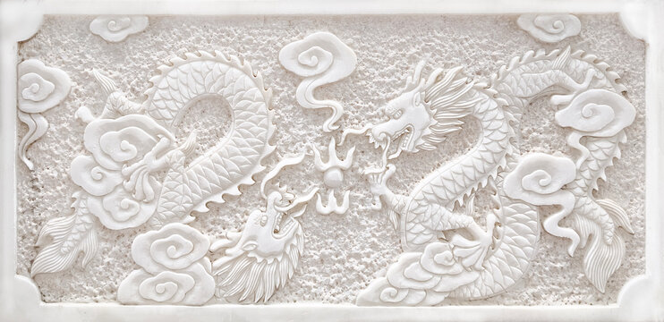 Traditional Chinese dragon bas-relief sculpture on white stone wall