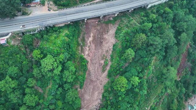Aerial view of soil erosion beneath elevated road and Highway infrastructure at risk from landslide