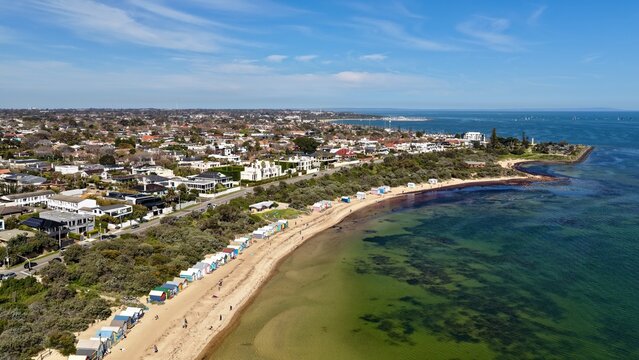 Brighton Beach, Melbourne, Victoria, Australia &ndash; 4K aerial drone view of iconic colourful bathing boxes, sandy beach, turquoise water, shoreline, luxury homes, residential suburb, Dendy Street Beach