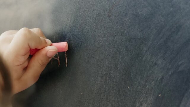 Close Up of Child Hand Writing on Blackboard With Pink Chalk in Classroom, Young Student Practicing Handwriting on Chalkboard Footage, Education and Learning Concept Video, School Kid Study Scene