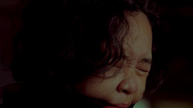 An emotional and disturbing close-up of a kidnapped woman with a black cloth gag in her mouth. She cries and winces in pain and despair, conveying deep psychological trauma and fear.
