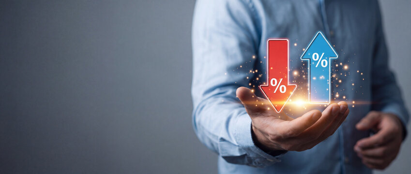 Businessman holding virtual glowing arrows with percentage symbols showing increase and decrease for interest rate fluctuation, financial investment growth, inflation control, and economic trends.