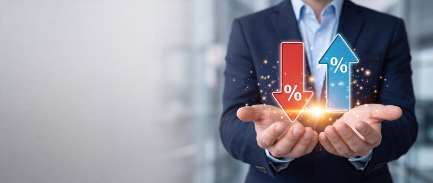 Businessman holding glowing up and down arrows with percentage signs, representing interest rate fluctuations, financial market volatility, economic growth, and investment risk management.