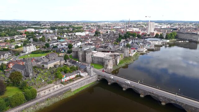 Dynamic drone of King John's Castle historical landmark on waterfront in Limerick city, Ireland